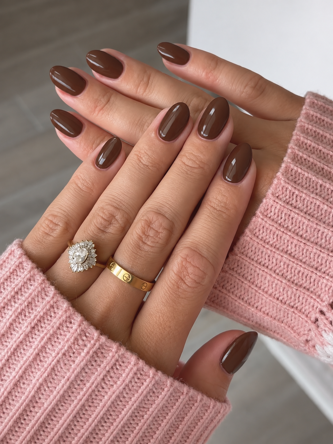 Medium oval nails painted glossy warm walnut brown.