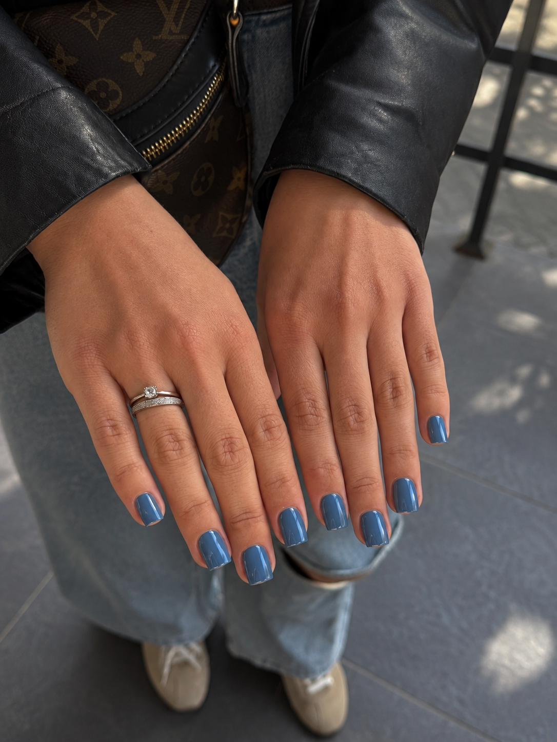 Short soft-square nails painted glossy slate blue.