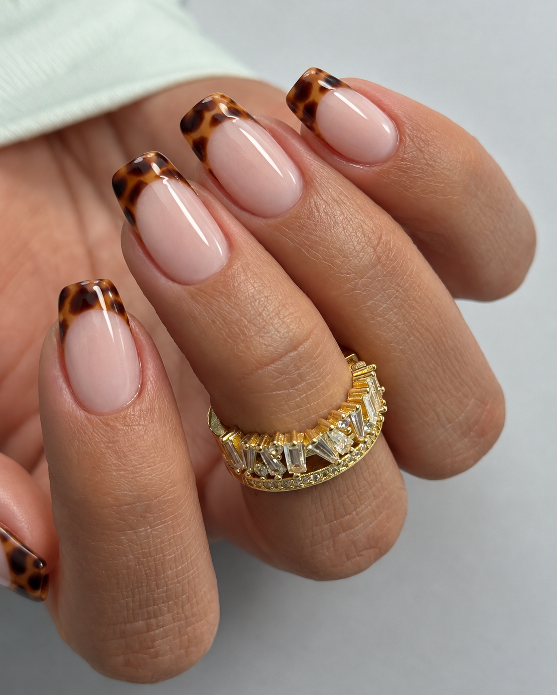 Rosy soft-square nails with amber-and-brown tortoiseshell French tips.