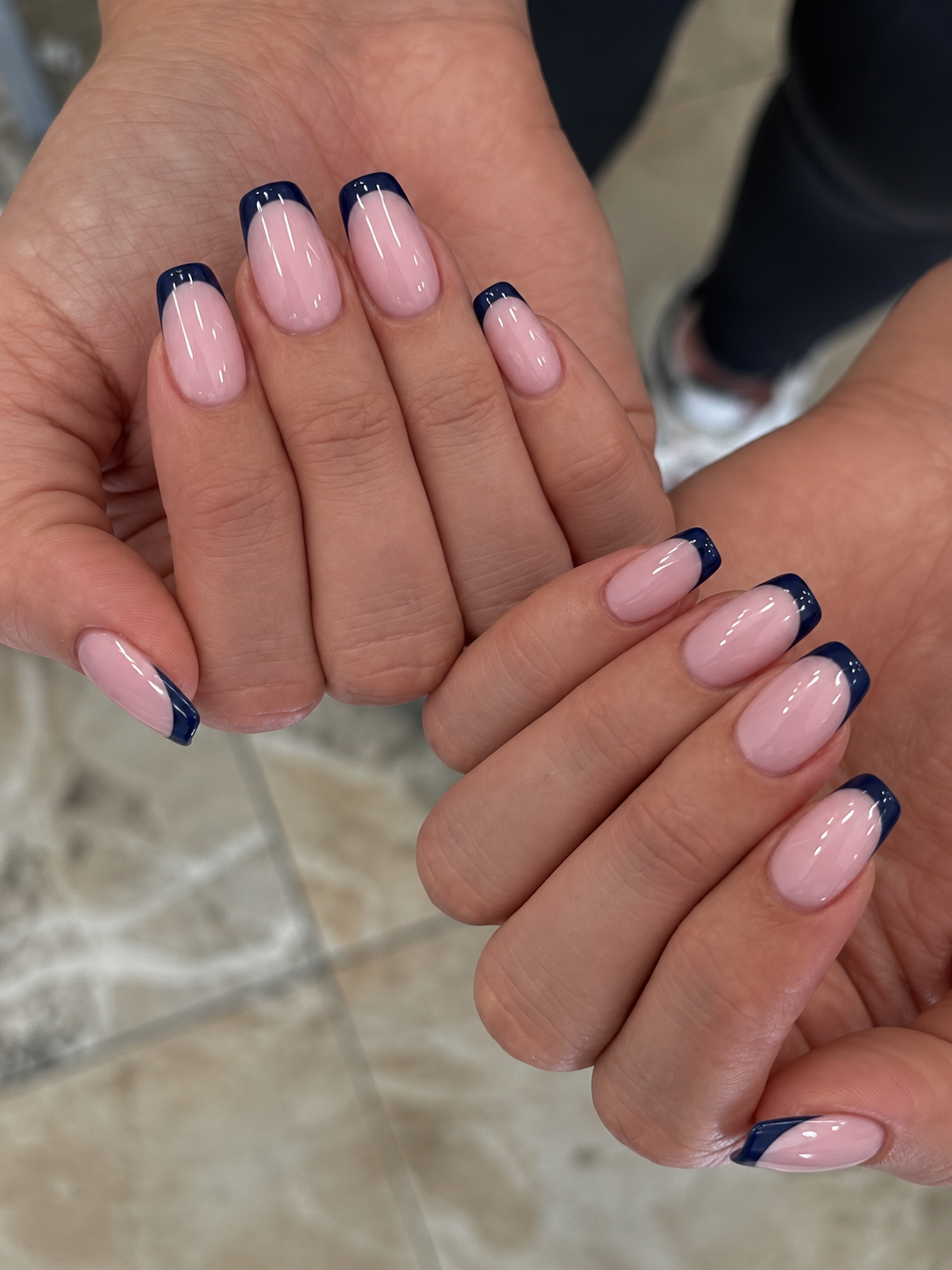 Milky pink soft-square nails with glossy navy French tips.