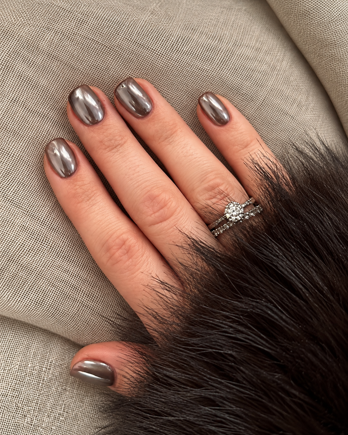 Short oval nails with a smooth pewter chrome finish.