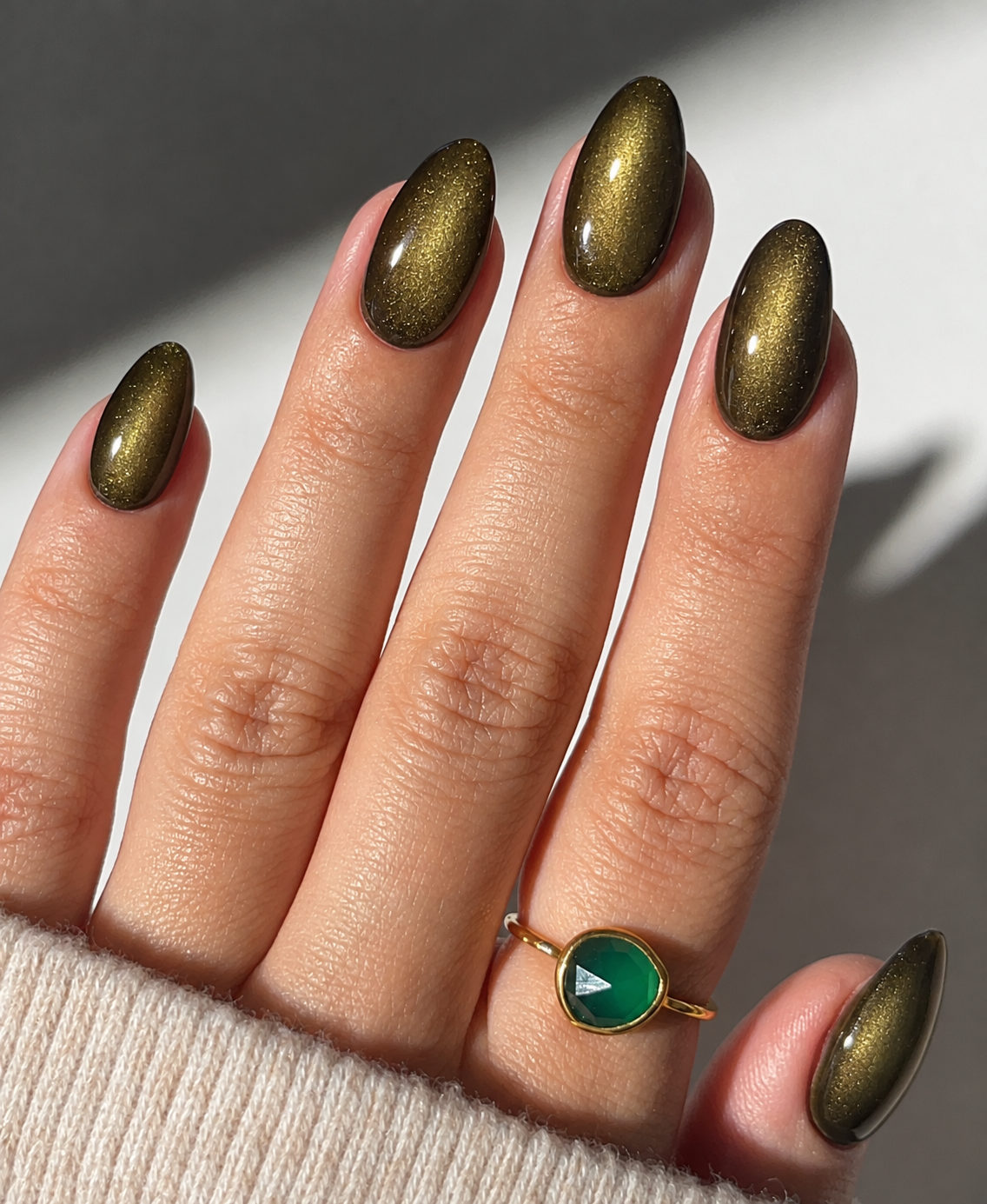 Olive almond nails with a broad velvet-like magnetic glow.