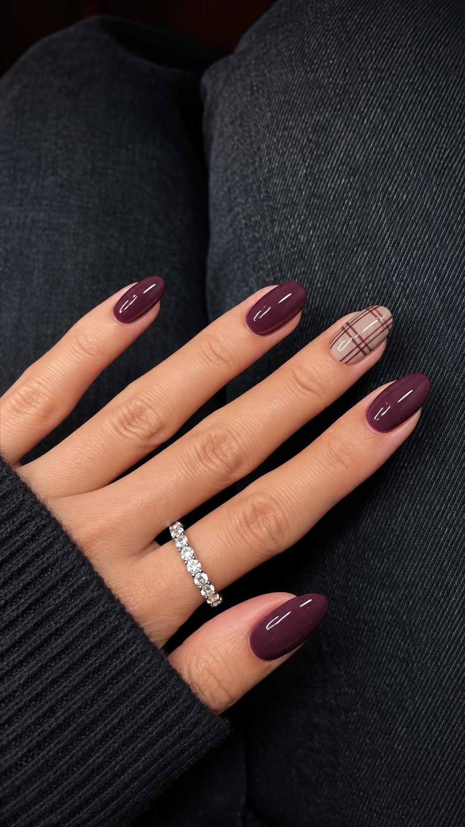 Muted plum nails with a taupe ring-finger windowpane accent.