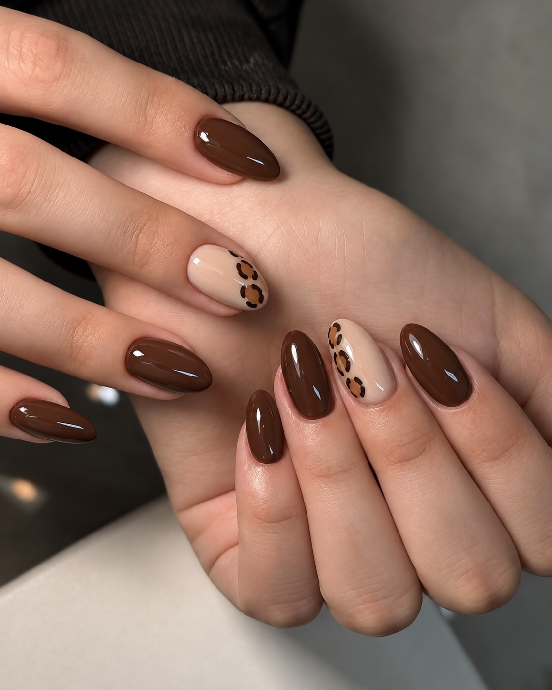 Walnut nails with a small leopard-print panel on a beige ring-finger accent.