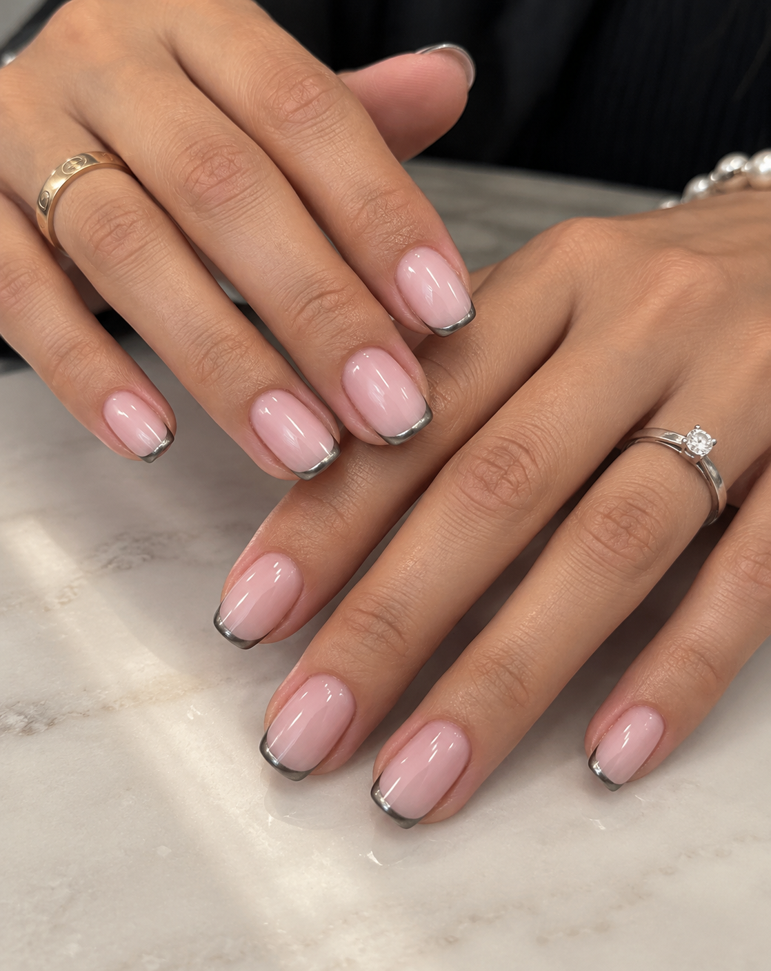 Milky rose nails with fine pewter-gray French edges.