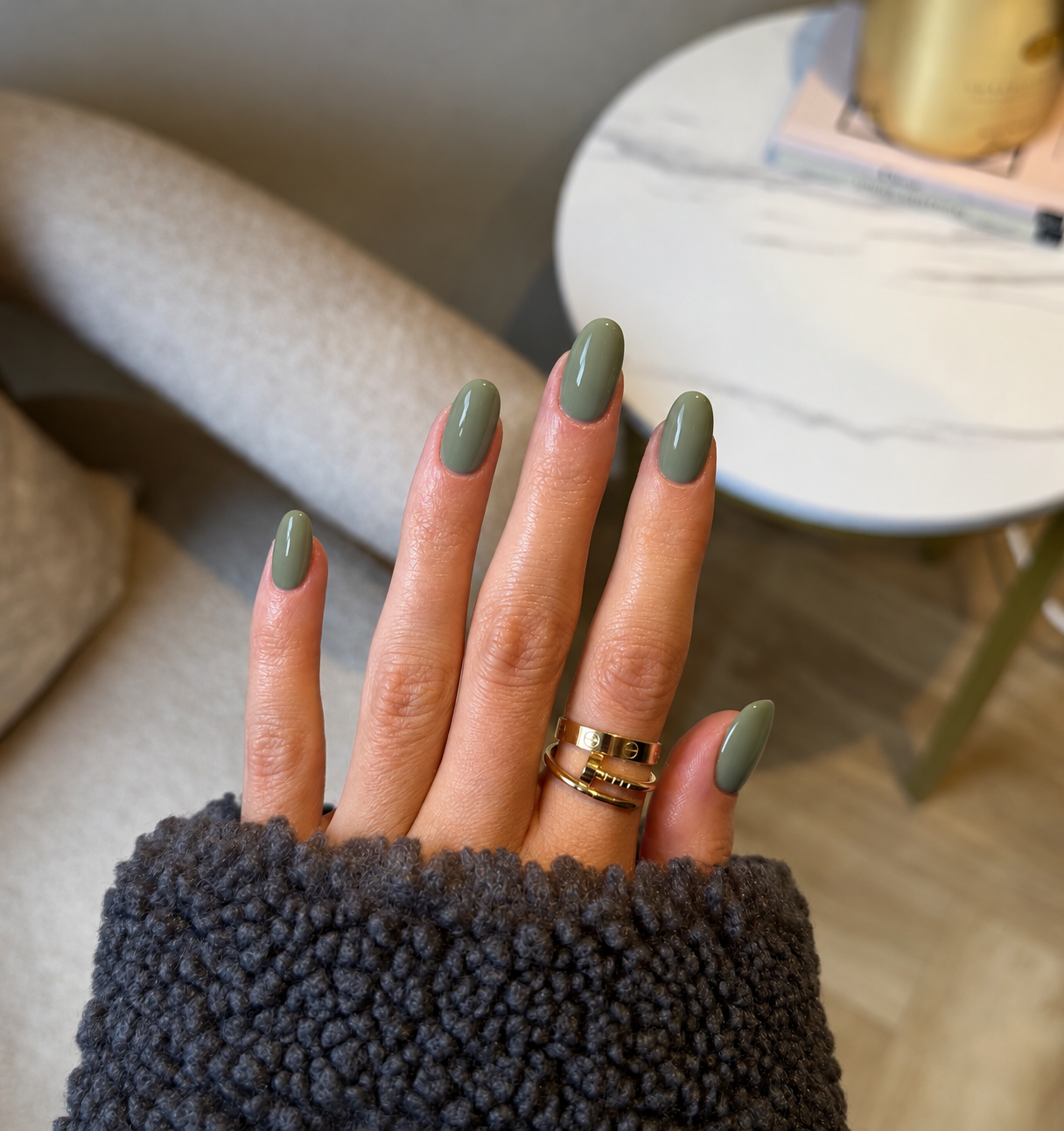 Short soft-square nails with creamy muted gray-sage polish.