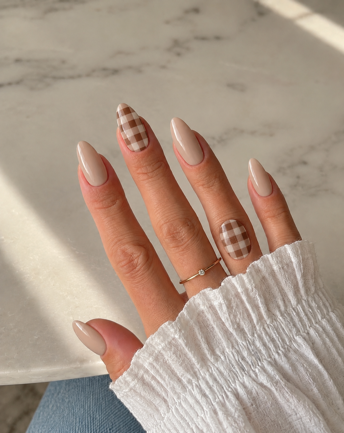 Latte nails with cocoa-and-latte gingham on the index and ring fingers.